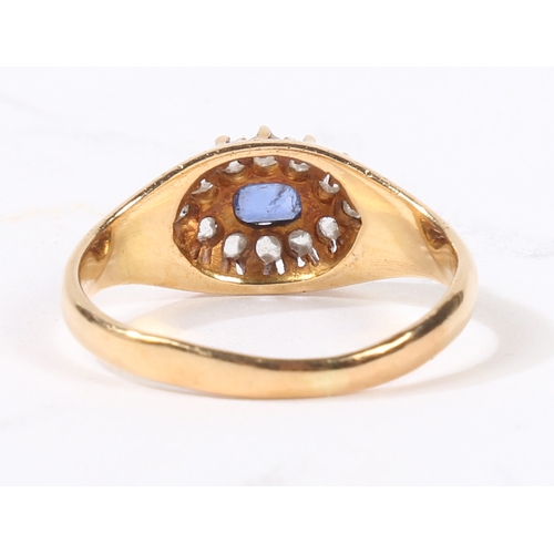 31 - AN 18 CARAT GOLD SAPPHIRE AND DIAMOND RING. the central rectangular facet cut sapphire surrounded by... 