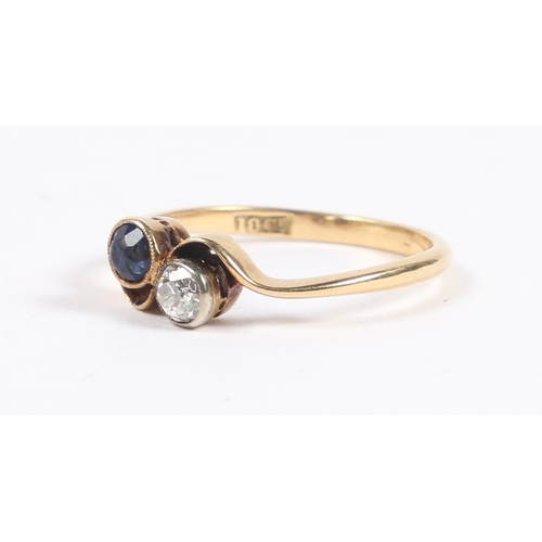 33 - AN 18 CARAT GOLD, SAPPHIRE AND DIAMOND RING. the cross-over head set with a round cut diamond and a ... 