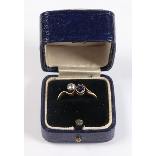 33 - AN 18 CARAT GOLD, SAPPHIRE AND DIAMOND RING. the cross-over head set with a round cut diamond and a ... 