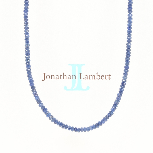 34 - A SAPPHIRE AND STERLING SILVER NECKLACE. formed from facet cut sapphire beads, with silver gilt magn... 