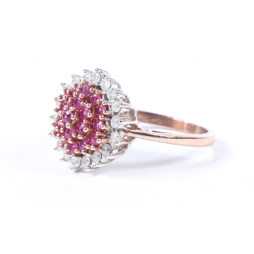 36 - A YELLOW METAL, RUBY AND DIAMOND CLUSTER RING. the head set with a central cluster of diamonds surro... 