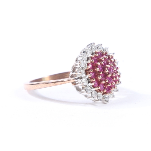 36 - A YELLOW METAL, RUBY AND DIAMOND CLUSTER RING. the head set with a central cluster of diamonds surro... 