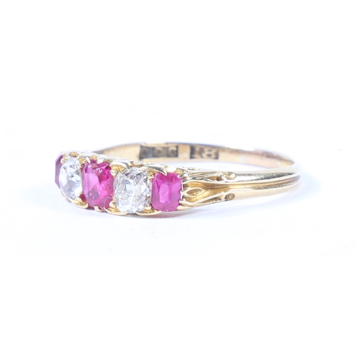 37 - AN 18 CARAT GOLD, RUBY AND DIAMOND RING. the scroll engraved head set with three rubies interspersed... 