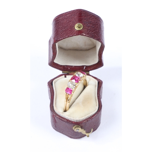 37 - AN 18 CARAT GOLD, RUBY AND DIAMOND RING. the scroll engraved head set with three rubies interspersed... 