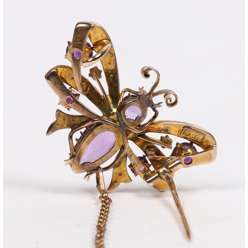 40 - A 9 CARAT GOLD, AMETHYST AND SEED PEARL BUTTERFLY BROOCH. modelled with wings spread, with garnet se... 