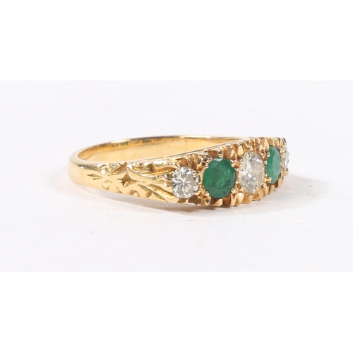 41 - AN 18 CARAT GOLD, EMERALD AND DIAMOND RING. the head set with three round cut diamonds and two round... 