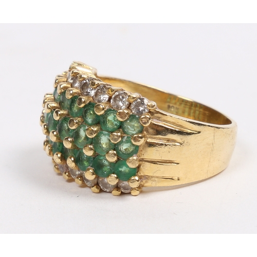 42 - AN 18 CARAT GOLD, EMERALD AND DIAMOND RING. set with three central rows of eight round cut emeralds ... 