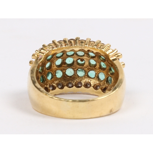 42 - AN 18 CARAT GOLD, EMERALD AND DIAMOND RING. set with three central rows of eight round cut emeralds ... 