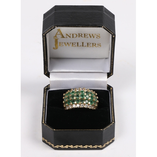 42 - AN 18 CARAT GOLD, EMERALD AND DIAMOND RING. set with three central rows of eight round cut emeralds ... 