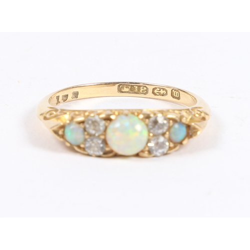 46 - A VICTORIAN 18 CARAT GOLD, OPAL AND DIAMOND RING. the central round cut diamond flanked by four roun... 