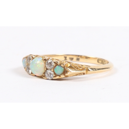 46 - A VICTORIAN 18 CARAT GOLD, OPAL AND DIAMOND RING. the central round cut diamond flanked by four roun... 