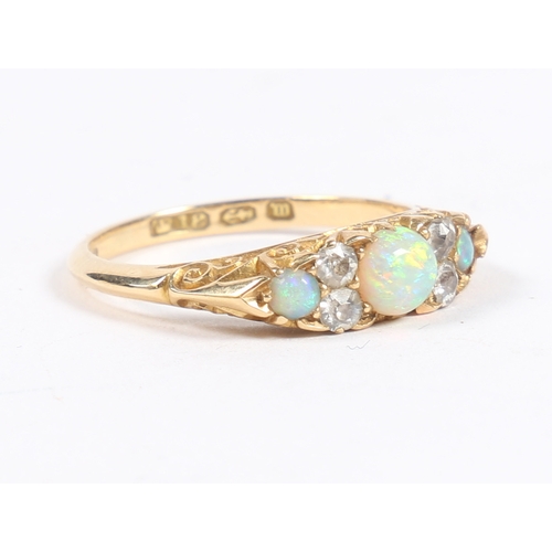 46 - A VICTORIAN 18 CARAT GOLD, OPAL AND DIAMOND RING. the central round cut diamond flanked by four roun... 