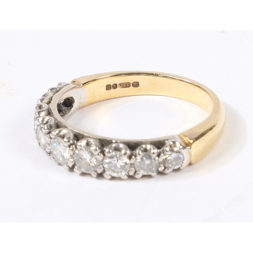 5 - AN 18 CARAT GOLD AND DIAMOND RING. the head set with nine graduated round cut diamonds, ring size L,... 