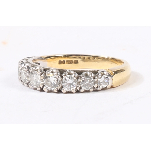 5 - AN 18 CARAT GOLD AND DIAMOND RING. the head set with nine graduated round cut diamonds, ring size L,... 