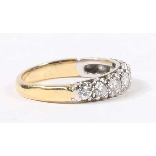 5 - AN 18 CARAT GOLD AND DIAMOND RING. the head set with nine graduated round cut diamonds, ring size L,... 