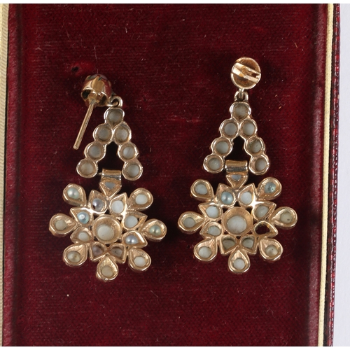 51 - A PAIR OF YELLOW METAL AND PEARL EARRINGS. the drops in the form of stylised flower heads, 38.5mm dr... 