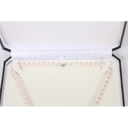 52 - A SINGLE STRAND PEARL NECKLACE. the single strand necklace with 18 carat white gold clasp of orb for... 