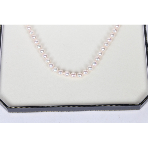 52 - A SINGLE STRAND PEARL NECKLACE. the single strand necklace with 18 carat white gold clasp of orb for... 