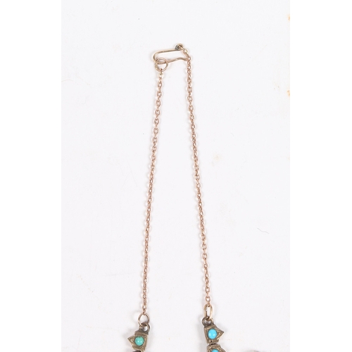 55 - A WHITE METAL AND TURQUOISE NECKLACE. formed from graduated stylised leaf and orb form drops, with l... 