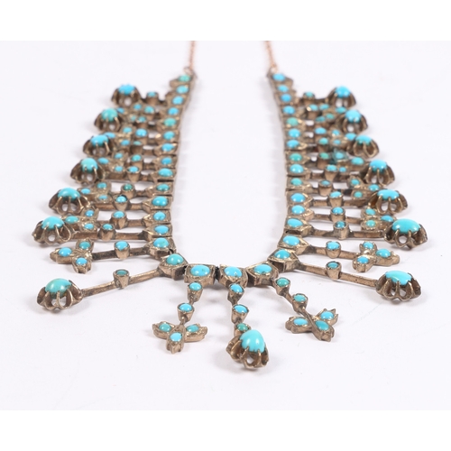 55 - A WHITE METAL AND TURQUOISE NECKLACE. formed from graduated stylised leaf and orb form drops, with l... 