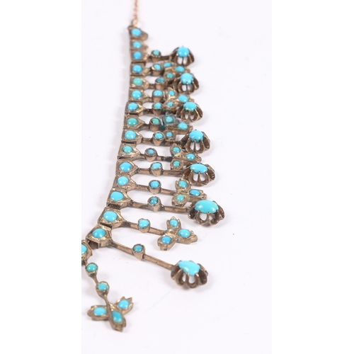 55 - A WHITE METAL AND TURQUOISE NECKLACE. formed from graduated stylised leaf and orb form drops, with l... 