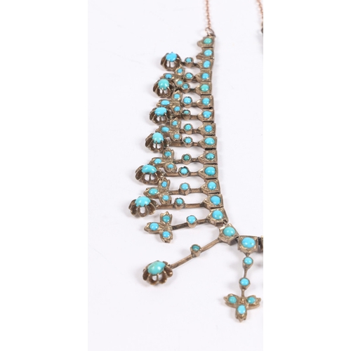 55 - A WHITE METAL AND TURQUOISE NECKLACE. formed from graduated stylised leaf and orb form drops, with l... 