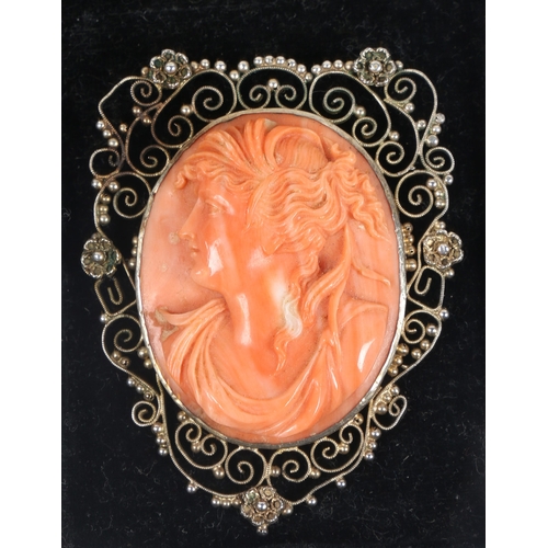 59 - A SILVER GILT CORAL CAMEO BROOCH. the central panel with depiction of a classical lady in profile, s... 