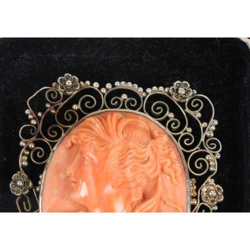 59 - A SILVER GILT CORAL CAMEO BROOCH. the central panel with depiction of a classical lady in profile, s... 