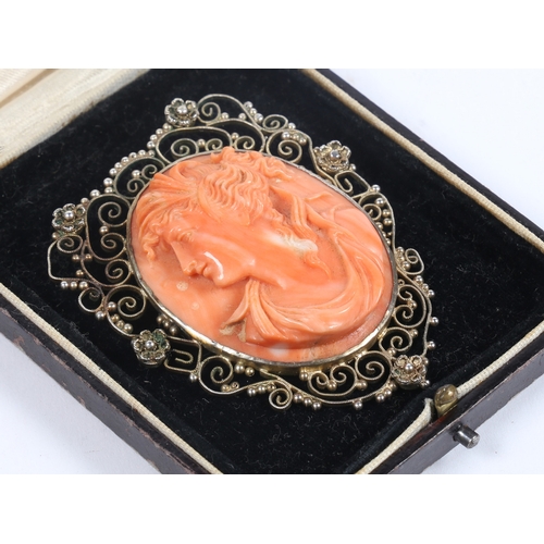 59 - A SILVER GILT CORAL CAMEO BROOCH. the central panel with depiction of a classical lady in profile, s... 