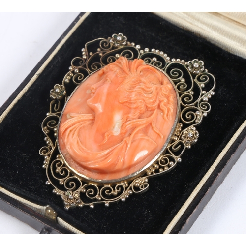 59 - A SILVER GILT CORAL CAMEO BROOCH. the central panel with depiction of a classical lady in profile, s... 