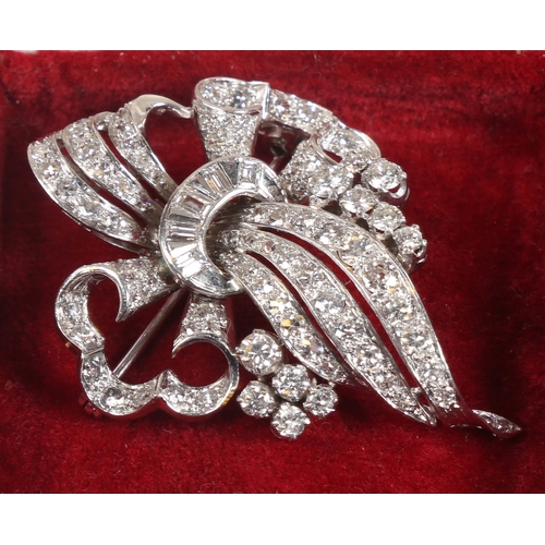 6 - A WHITE METAL AND DIAMOND BROOCH. the pierced scroll and trefoil form brooch set throughout with bri... 