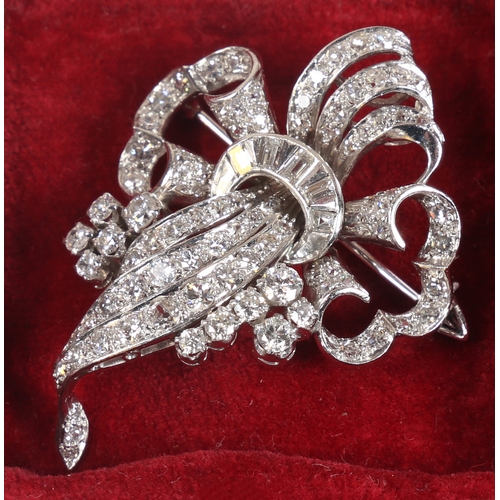 6 - A WHITE METAL AND DIAMOND BROOCH. the pierced scroll and trefoil form brooch set throughout with bri... 