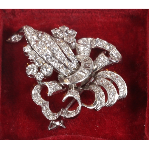 6 - A WHITE METAL AND DIAMOND BROOCH. the pierced scroll and trefoil form brooch set throughout with bri... 