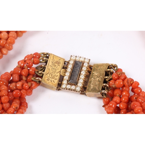 60 - A CORAL BEAD NECKLACE AND BRACELET (2). each formed from six interwoven strands of beads, with 14 ca... 