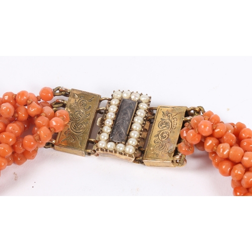 60 - A CORAL BEAD NECKLACE AND BRACELET (2). each formed from six interwoven strands of beads, with 14 ca... 