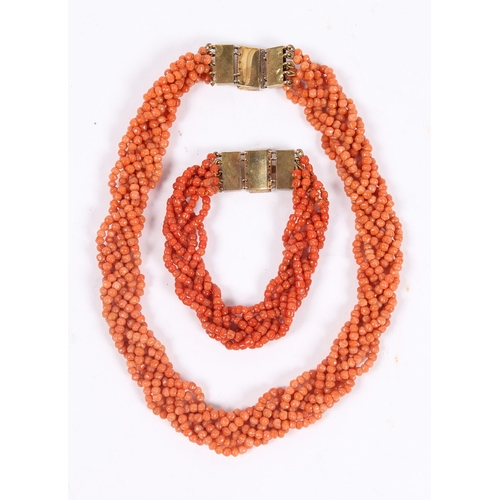 60 - A CORAL BEAD NECKLACE AND BRACELET (2). each formed from six interwoven strands of beads, with 14 ca... 