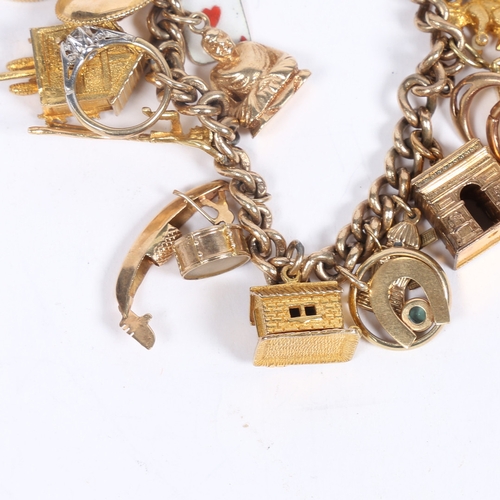 64 - A 9 CARAT GOLD CHARM BRACELET. set with 22 charms including a George V half sovereign 1907, cuckoo c... 