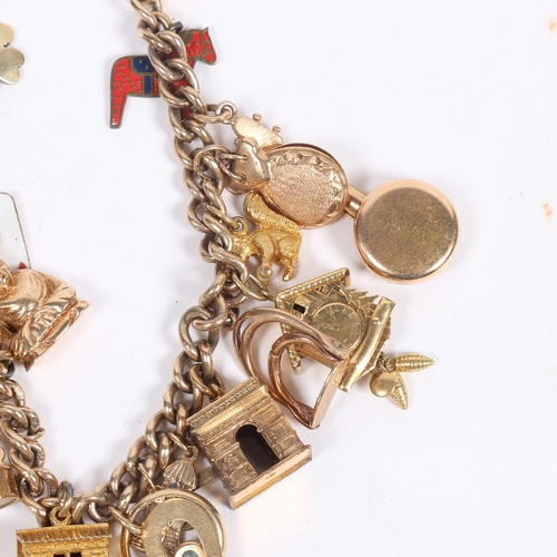 64 - A 9 CARAT GOLD CHARM BRACELET. set with 22 charms including a George V half sovereign 1907, cuckoo c... 