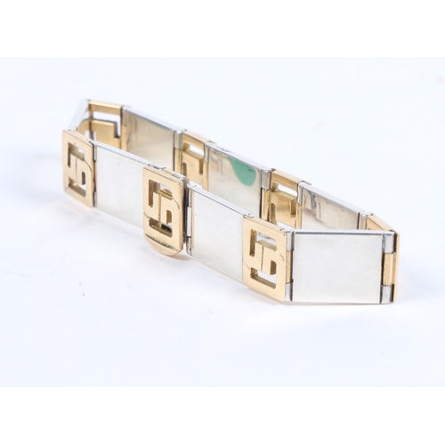 67 - A GUCCI 18 CARAT GOLD AND SILVER BRACELET. the bracelet formed from seven 18 carat gold interlocking... 