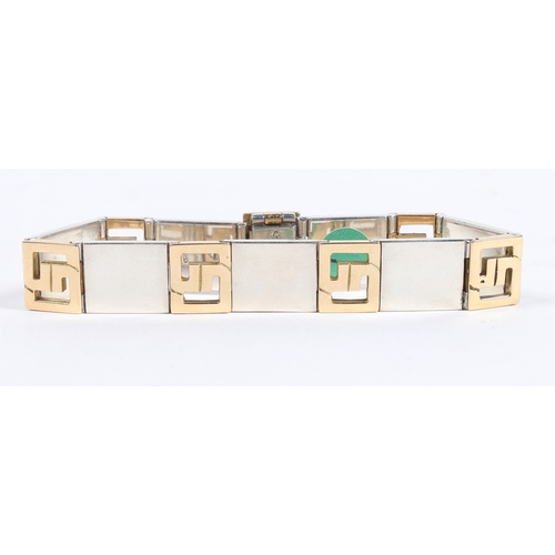 67 - A GUCCI 18 CARAT GOLD AND SILVER BRACELET. the bracelet formed from seven 18 carat gold interlocking... 