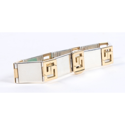 67 - A GUCCI 18 CARAT GOLD AND SILVER BRACELET. the bracelet formed from seven 18 carat gold interlocking... 