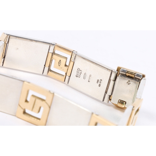 67 - A GUCCI 18 CARAT GOLD AND SILVER BRACELET. the bracelet formed from seven 18 carat gold interlocking... 