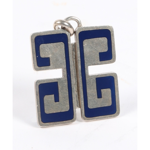 68 - A GUCCI SILVER AND BLUE ENAMEL PENDANT. modelled as two G's, hallmarked for London 1974, 39mm wide, ... 