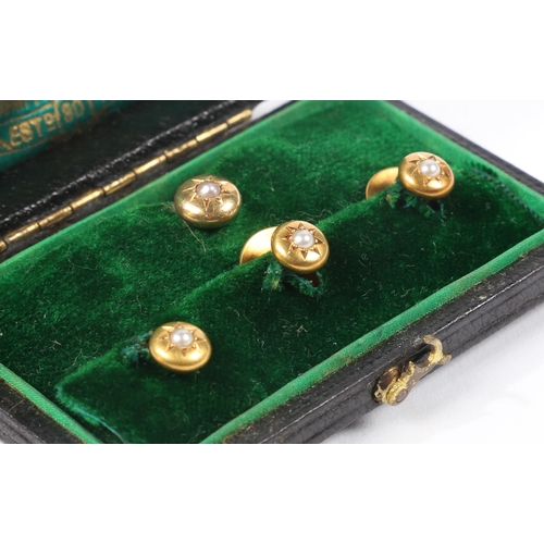 70 - A SET OF FOUR 15 CARAT GOLD AND PEARL DRESS STUDS. the star cur heads set with a central pearl, cons... 