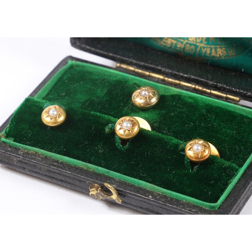 70 - A SET OF FOUR 15 CARAT GOLD AND PEARL DRESS STUDS. the star cur heads set with a central pearl, cons... 