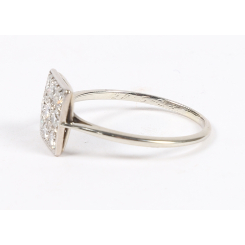 8 - A PLATINUM AND DIAMOND RING. the square head set with nine round cut diamonds, the interior of the b... 