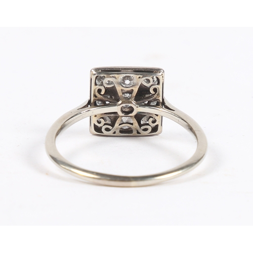 8 - A PLATINUM AND DIAMOND RING. the square head set with nine round cut diamonds, the interior of the b... 