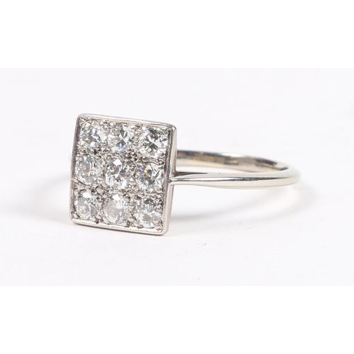 8 - A PLATINUM AND DIAMOND RING. the square head set with nine round cut diamonds, the interior of the b... 