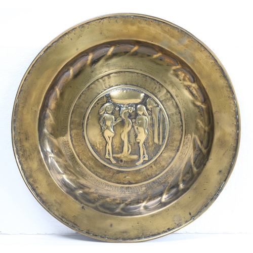 115 - A MID-16TH CENTURY BRASS ALMS DISH, NUREMBERG, CIRCA 1550. Decorated with Adam and Eve to the centre... 