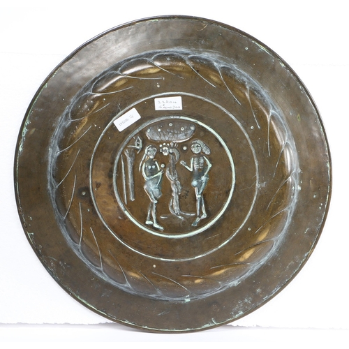 115 - A MID-16TH CENTURY BRASS ALMS DISH, NUREMBERG, CIRCA 1550. Decorated with Adam and Eve to the centre... 